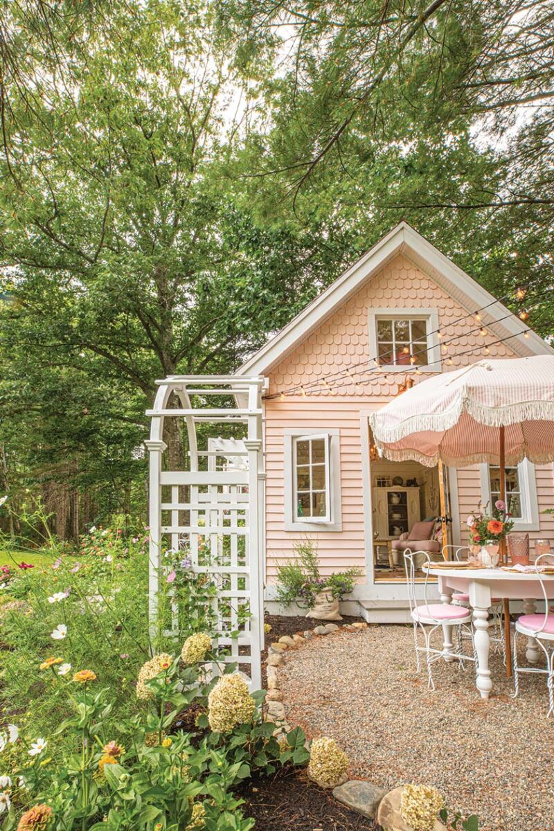 garden arbor and exterior of pink she shed and al fresco dining area