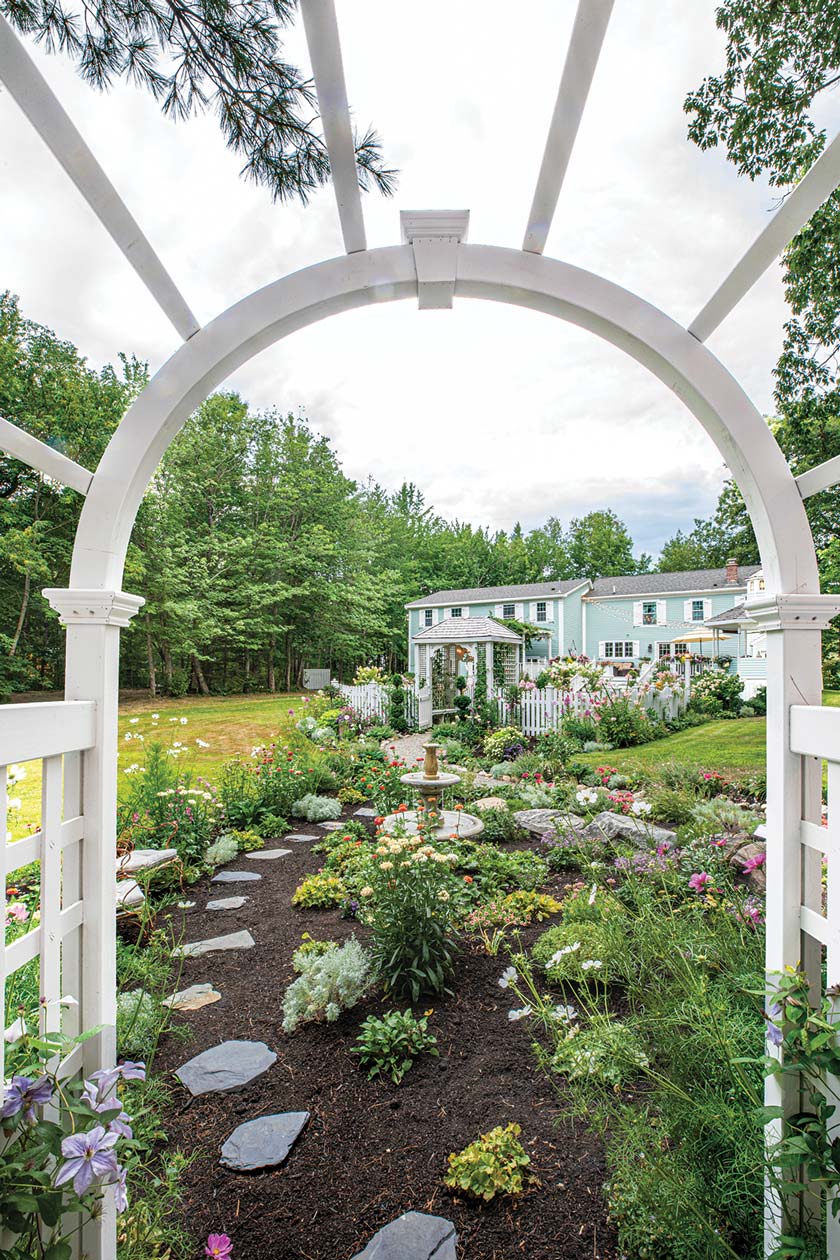 view of walkway and gardens in home gardens in Maine
