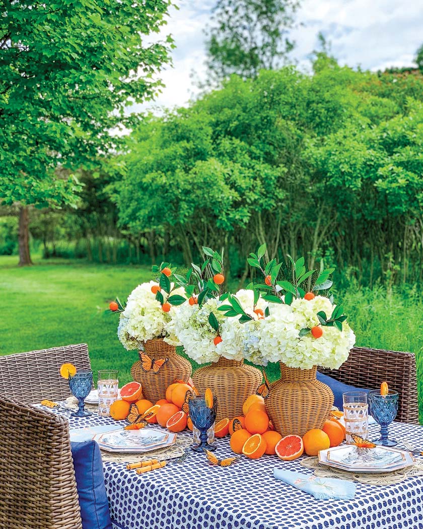 outdoor tablescape with orange and blue color scheme