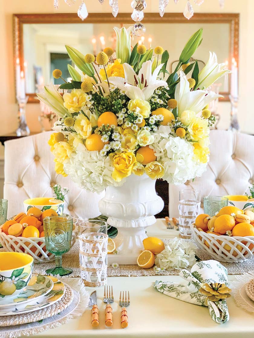 white lilies and oranges in central bouquet in citrus themed tablescape