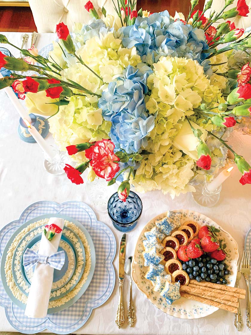 aerial view of red white and blue summer tablescape with hydrangeas and carnations