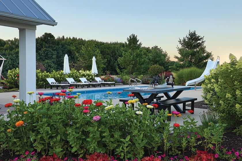 pool with slide and picnic area in backyard