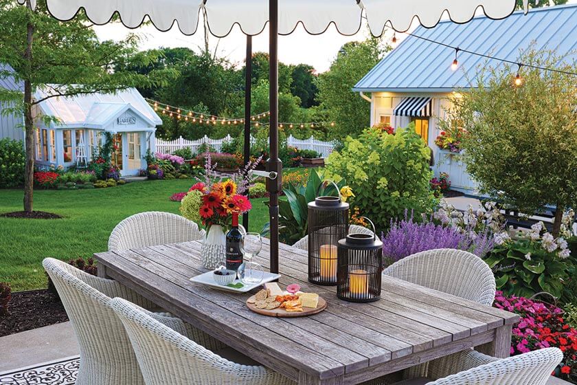 outdoor dining area and greenhouse in Michigan cottage gardens