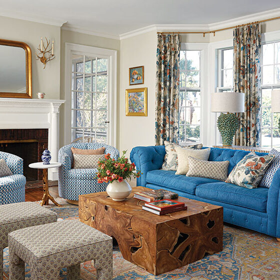 long view of living room showing mix of pattern and color in curtains decor and furniture