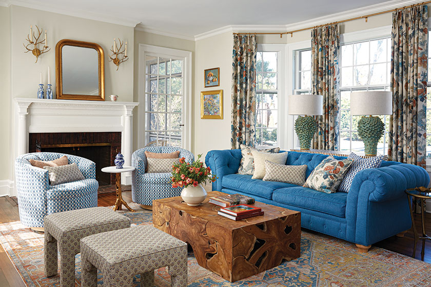 long view of living room showing mix of pattern and color in curtains decor and furniture