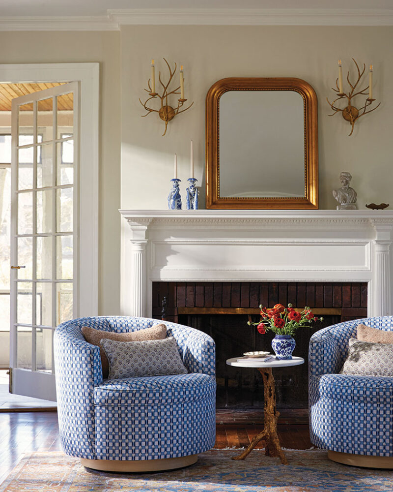 blue and white details of side chairs and decor surrounding mantel in redesigned living room