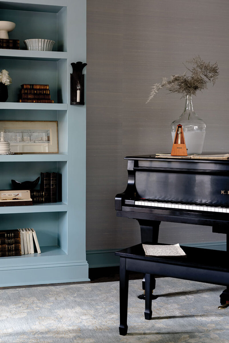 blue painted bookcase and piano in French farmhouse inspired home renovation