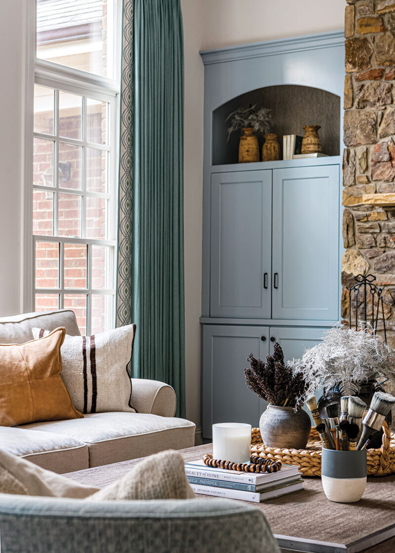 powder blue storage and brick fireplace surround in renovated French farmhouse inspired home