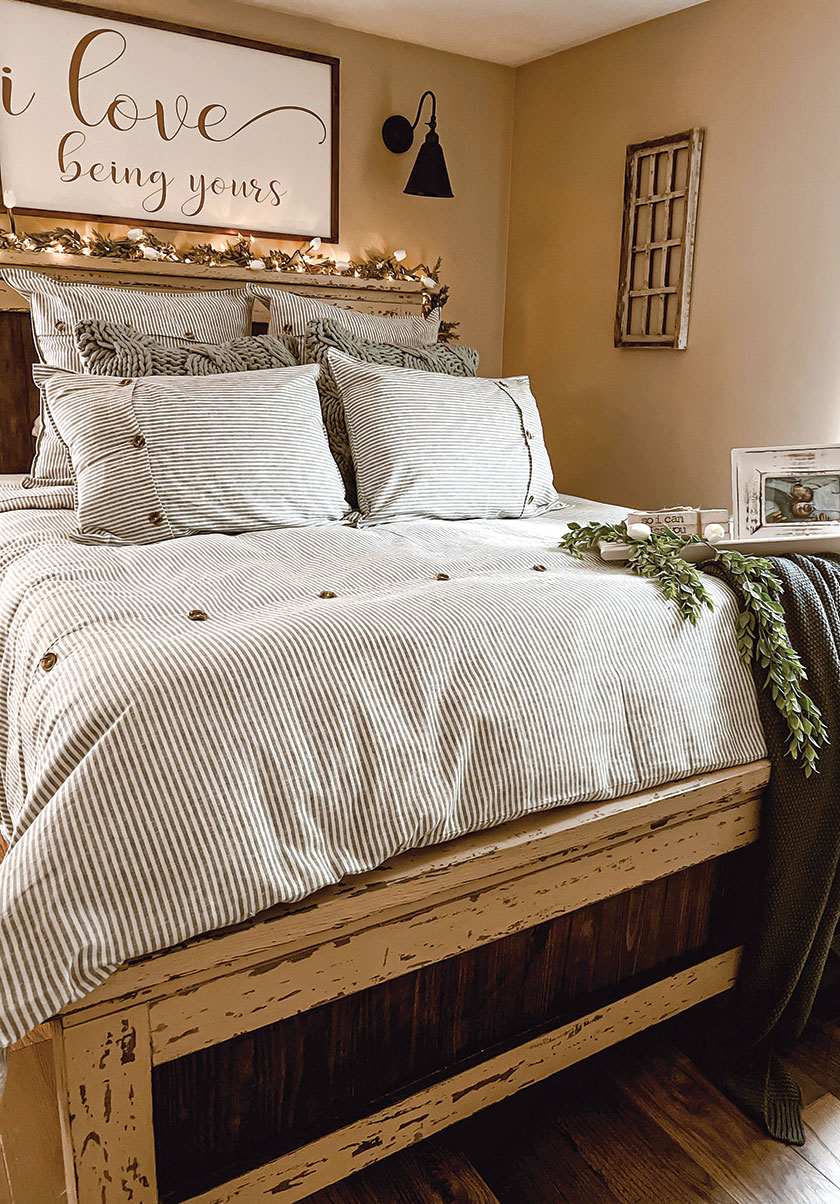 bedroom in Bryan Cosham's home with ticking pattern on bedding