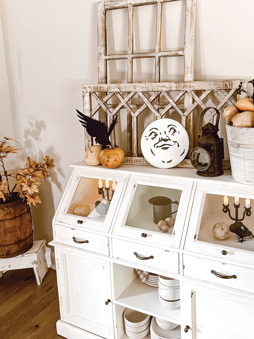 white shelving with moon face character and vintage collectibles