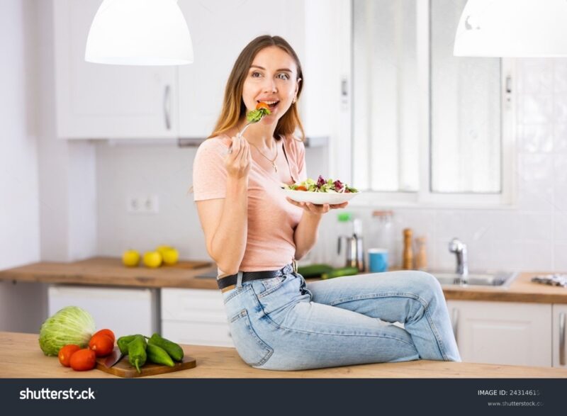 a english girl eating salad on kitchen table