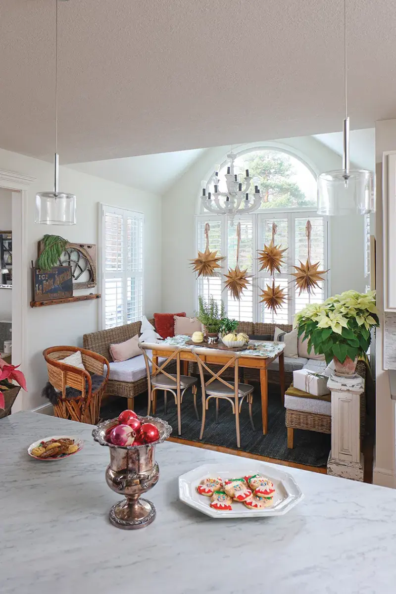 kitchen with Christmas cookies, pomegranates and view to breakfast nook in Michigan home decorated for the holidays