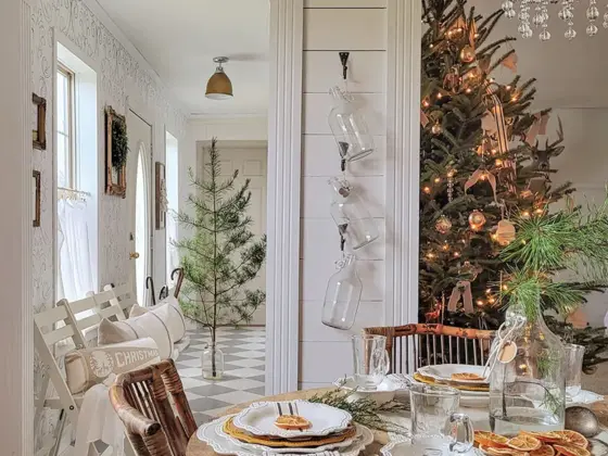 dining area with view to Christmas tree deocrated with lights and neutral ornaments