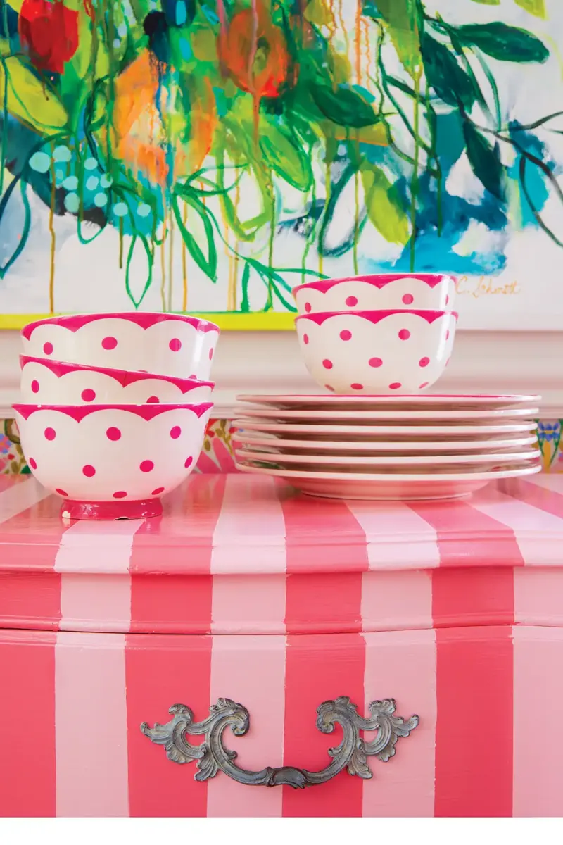 pink stripped dresser with pink and white polka dot dishes