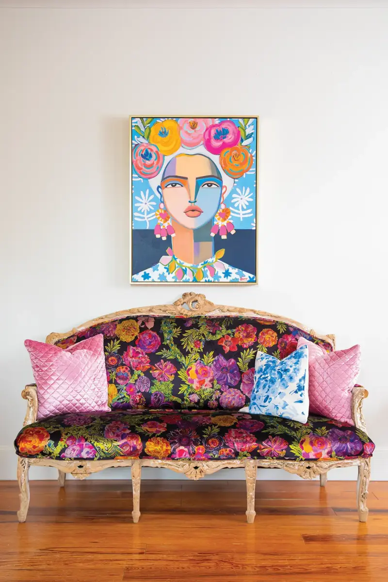 floral upholstery on couch echoed in art portrait of woman with flowers in her hair