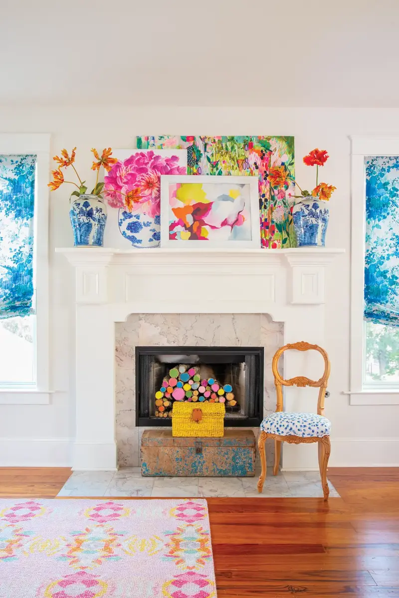 mantel with bright floral paintings and logs with eds painted in various colors
