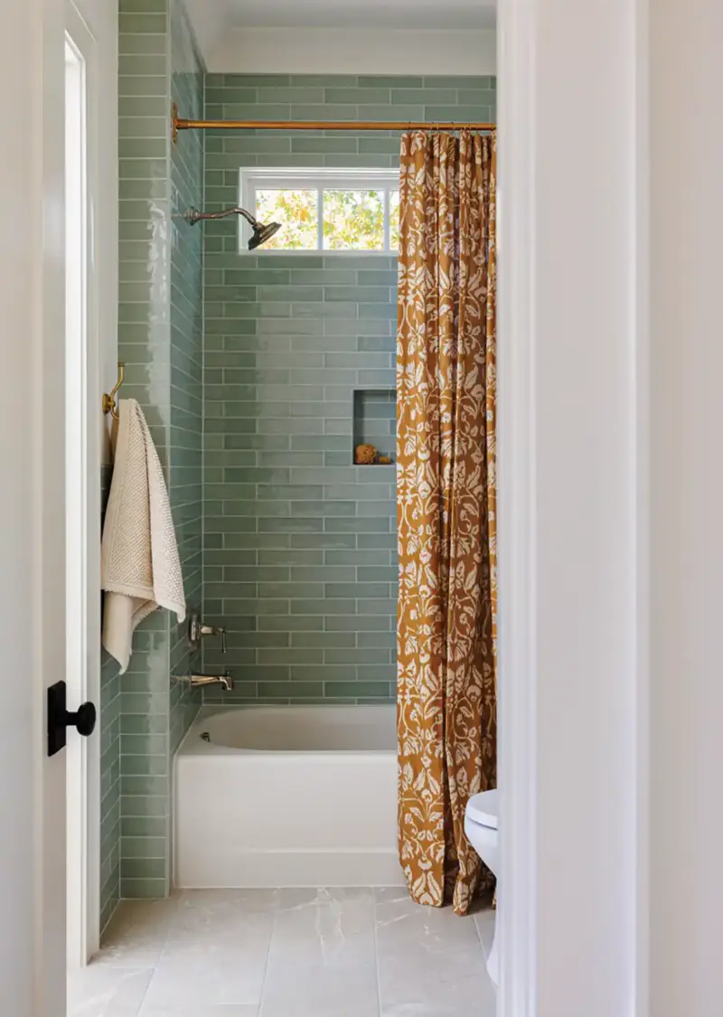 shower with teal tile and dark mustard damask curtain