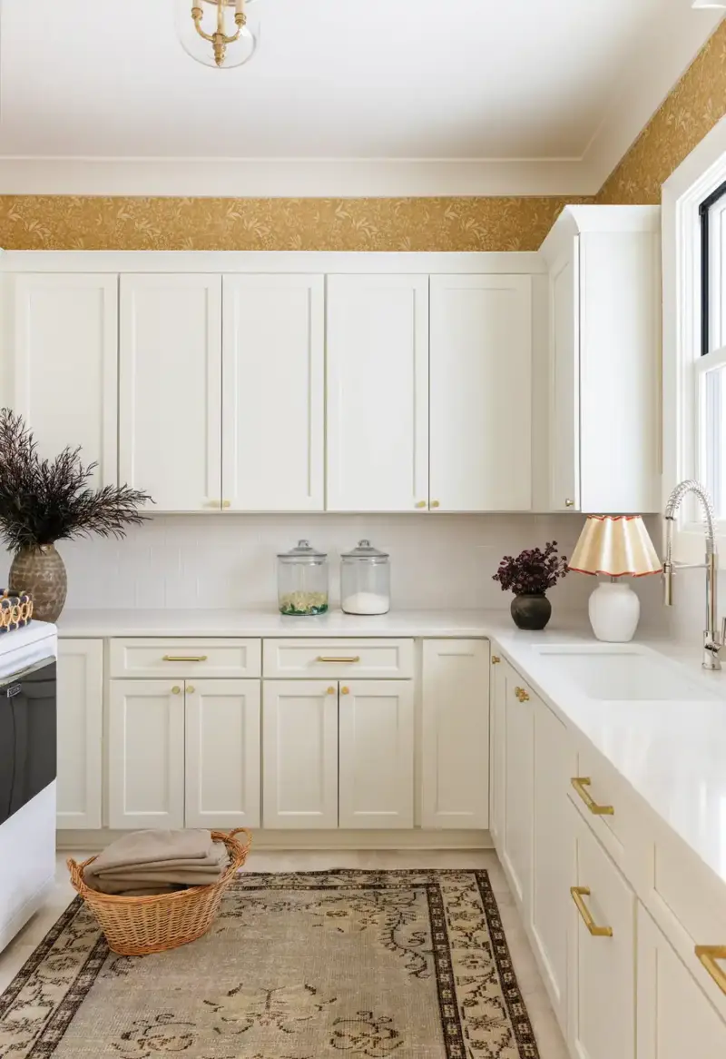 kitchen with white cabinetry and yellow wallpaper in Mallard House