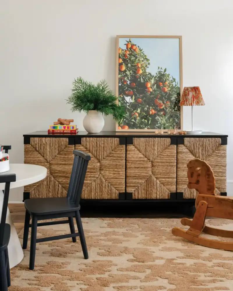 credenza with woven fronts and framed photo of apple tree in Mallard House play area