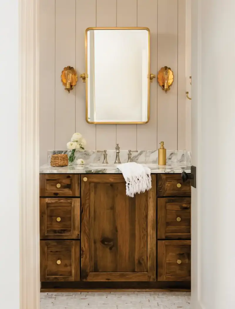 powder room with gold scones and beadboard in Mallard House