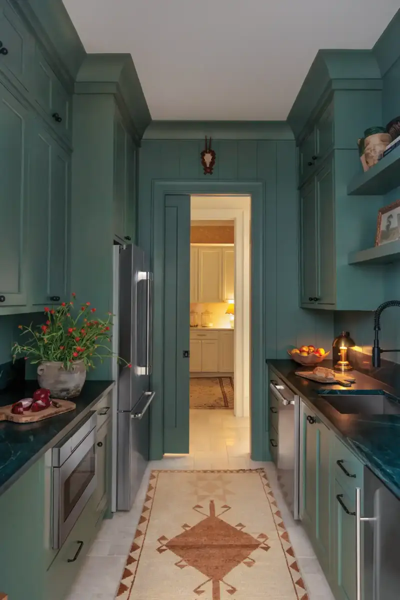 kitchen with teal cabinetry and pocket door