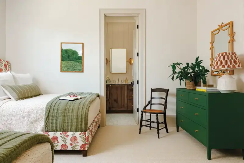 bedroom with green dresser and green bedding and apple patterns on bedframe upholstery