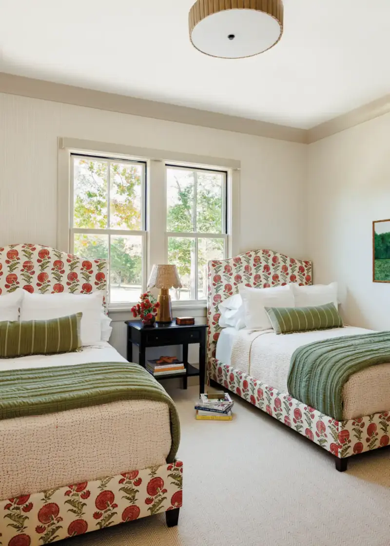 guest room with two bedframes upholstered in apple pattern block print.