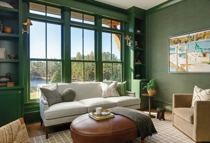 green secondary living room with a view to trees and lake in Mallard House