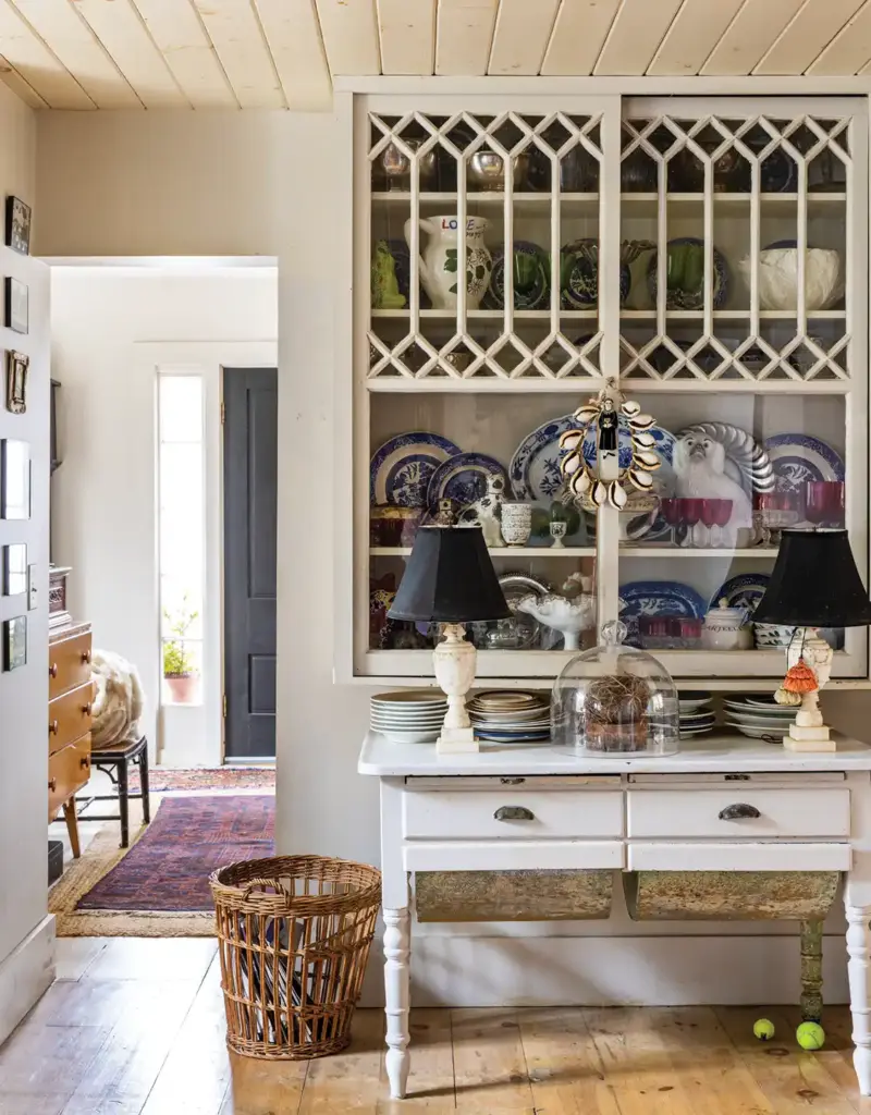 glass front cabinets display dish collection and seashell wreath