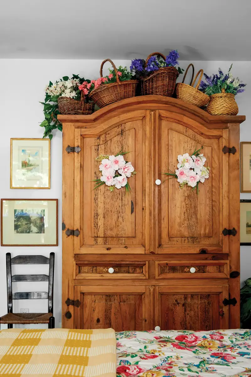 floral decor on top of wooden cabinet in 1939 cottage