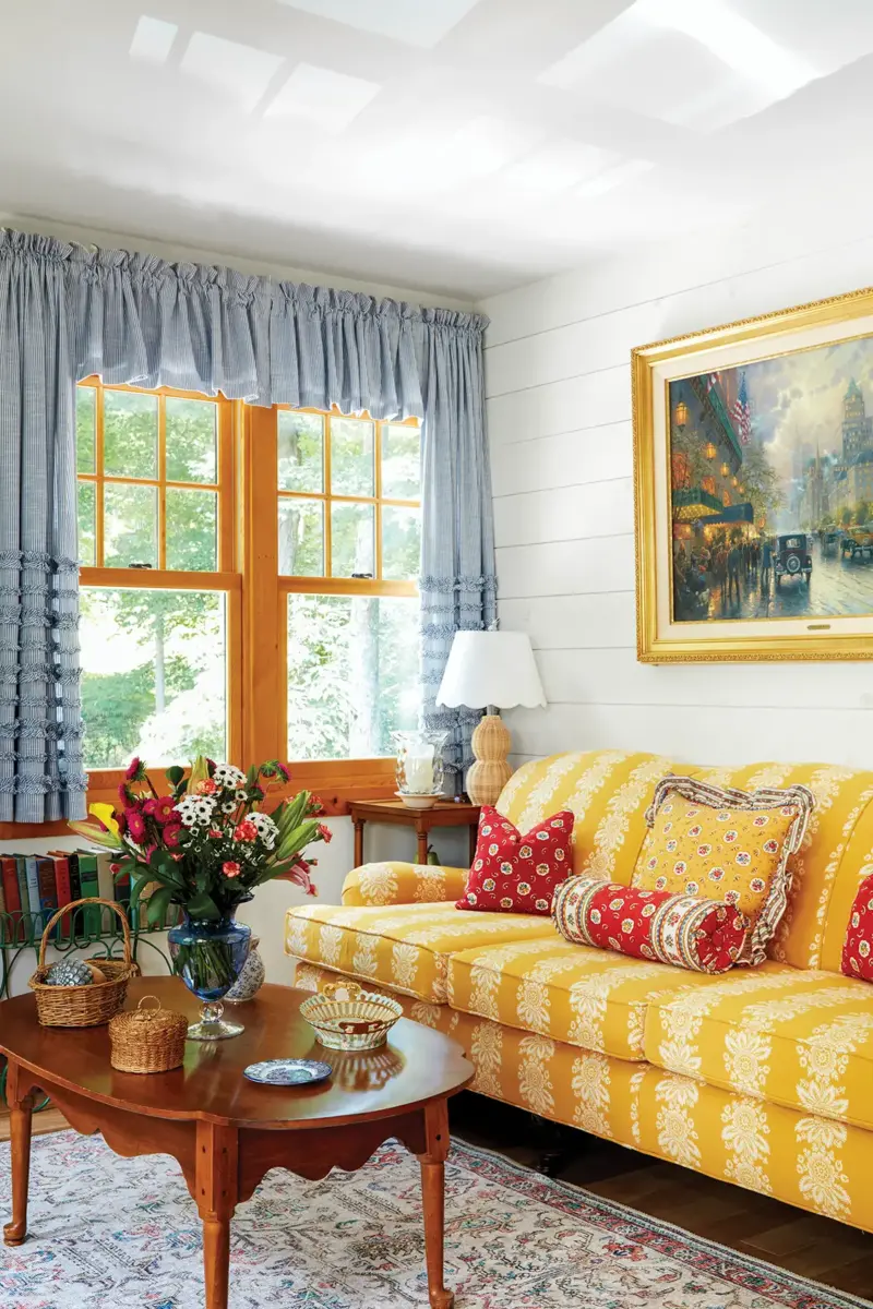 yellow couch and blue curtains in 1939 cottage