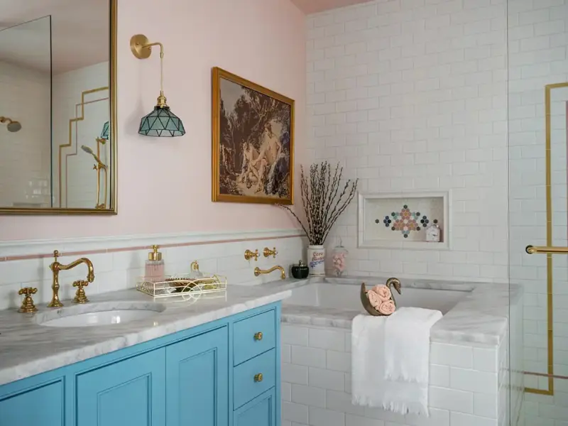 soaking tub in 1930 Tudor home with painting on wall above