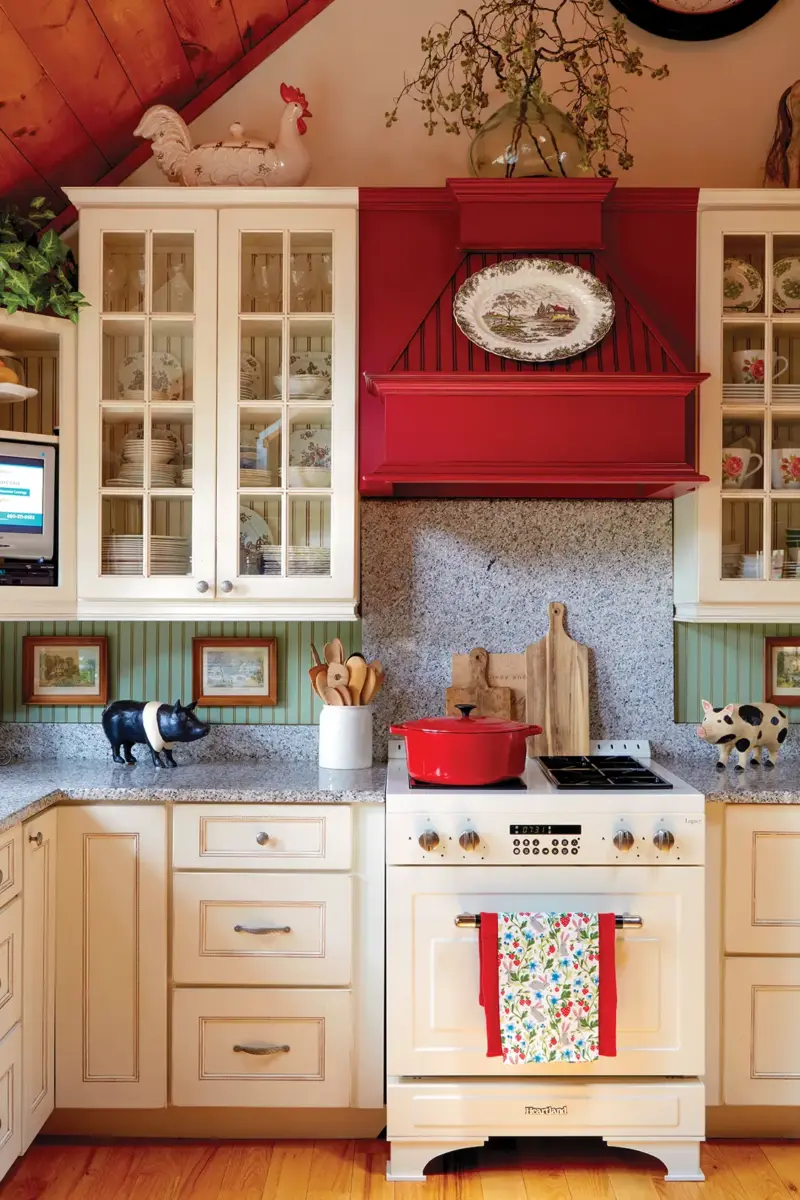 kitchen with red hood and white cabinetry