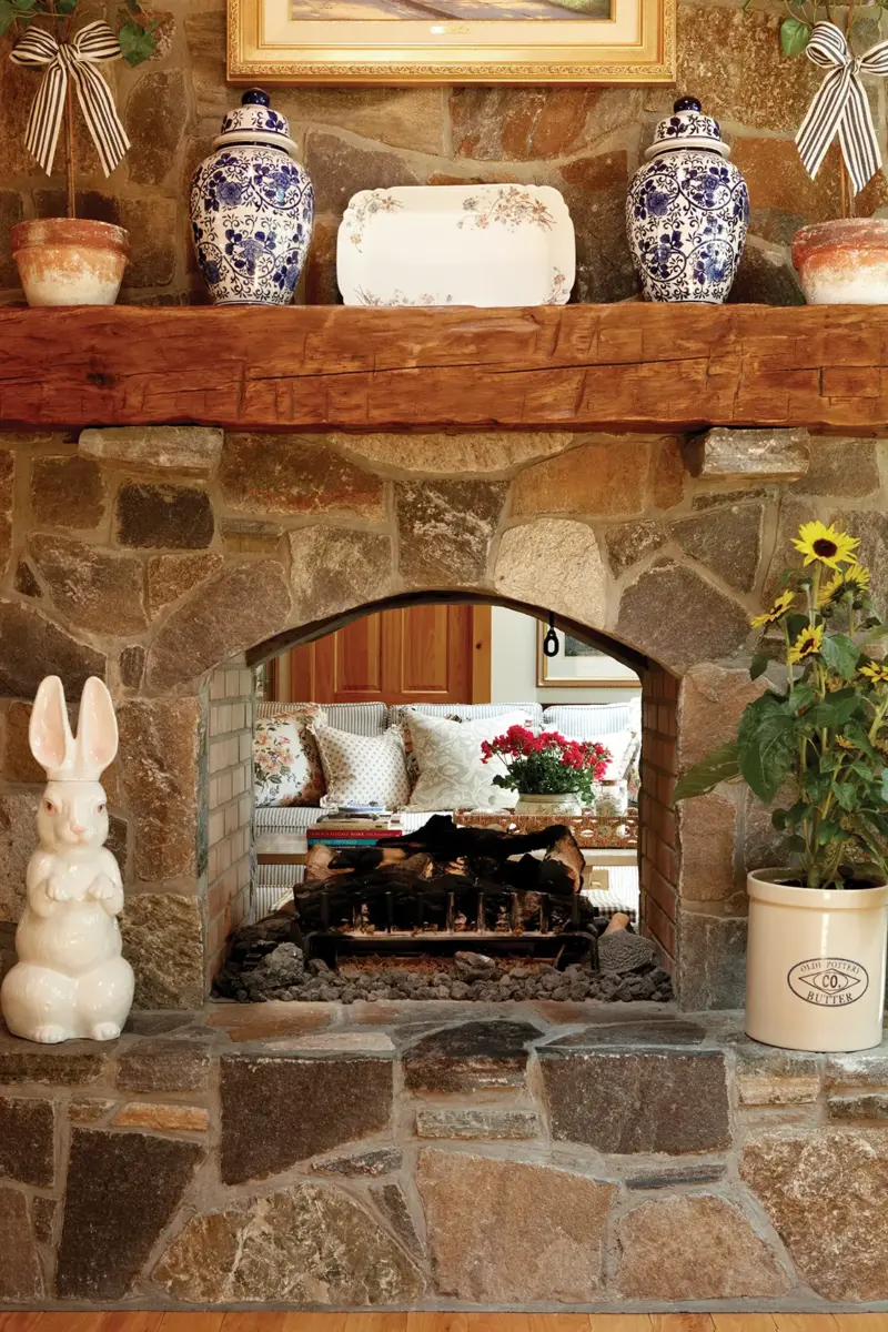 living room with traditional stone fireplace