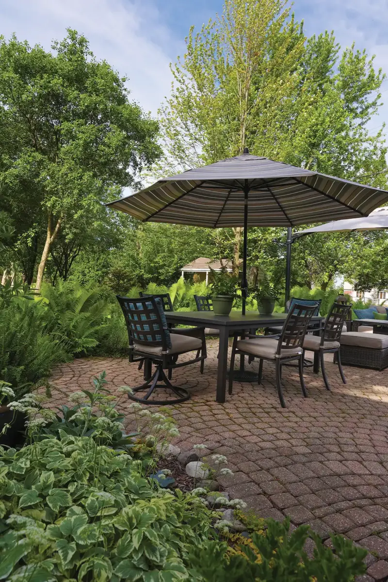 paved patio and lush landscaping in 1926 Tudor home