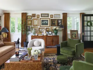 gallery wall in living room with green and dusty pink furniture