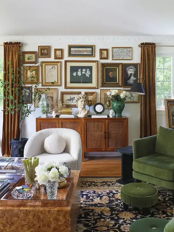 gallery wall in living room with green and dusty pink furniture