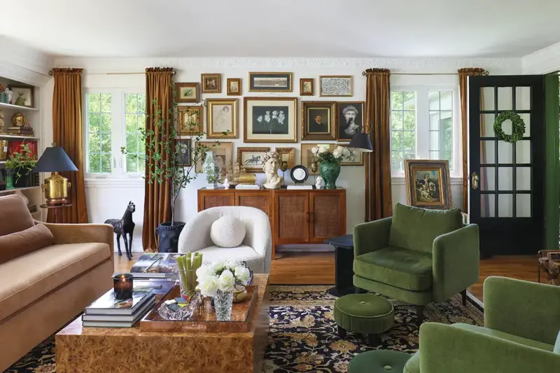 gallery wall in living room with green and dusty pink furniture