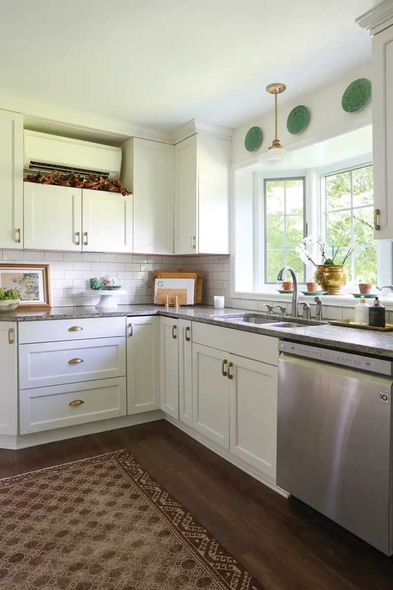 white kitchen with decorative green plates and white cabinetry in 1926 Tudor home refresh