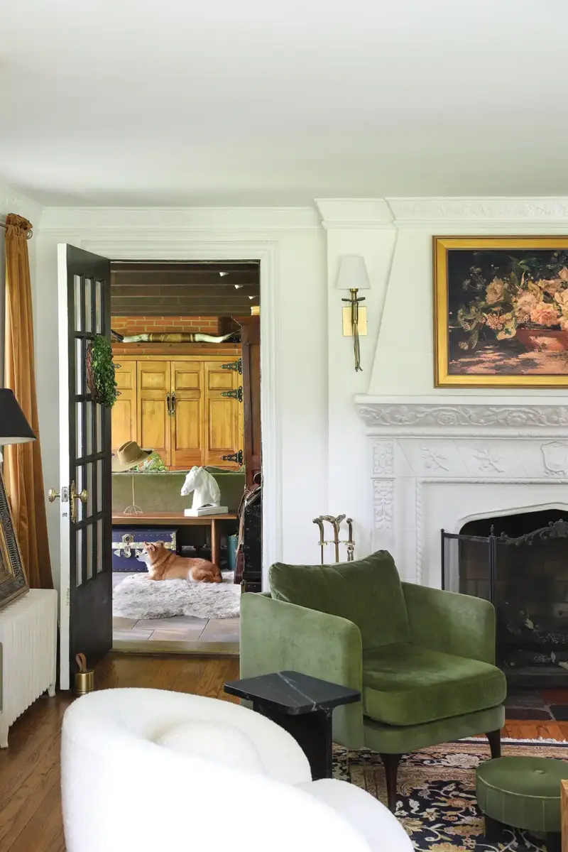 living room with view to hallway with pet dog and a decorative horse bust