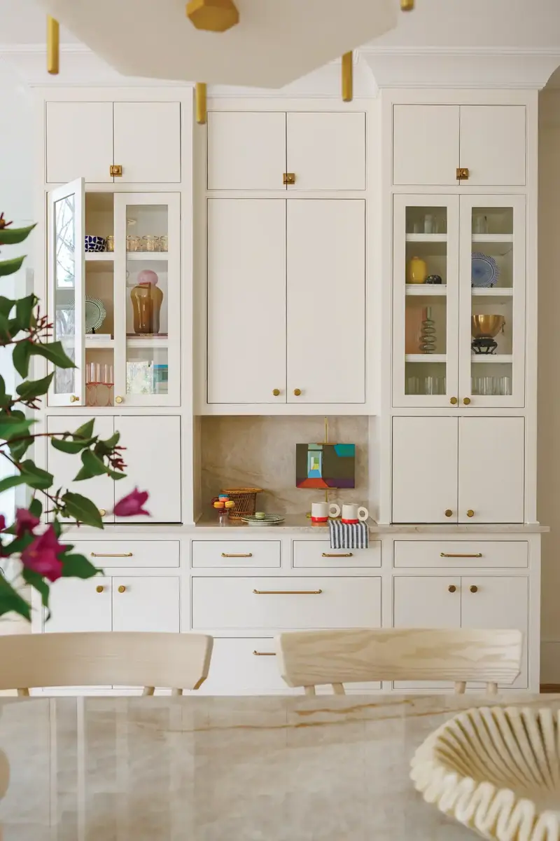 wall of white cabinetry with brass cabinet pulls in North Carolina renovated kitchen