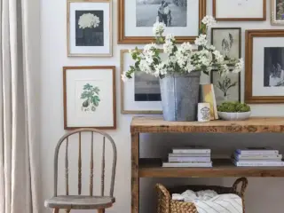 gallery wall of framed black and white and botanical art