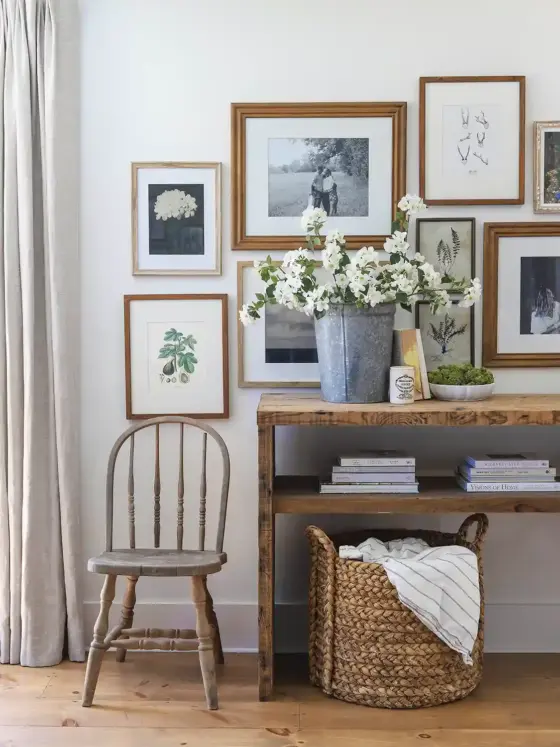 gallery wall of framed black and white and botanical art