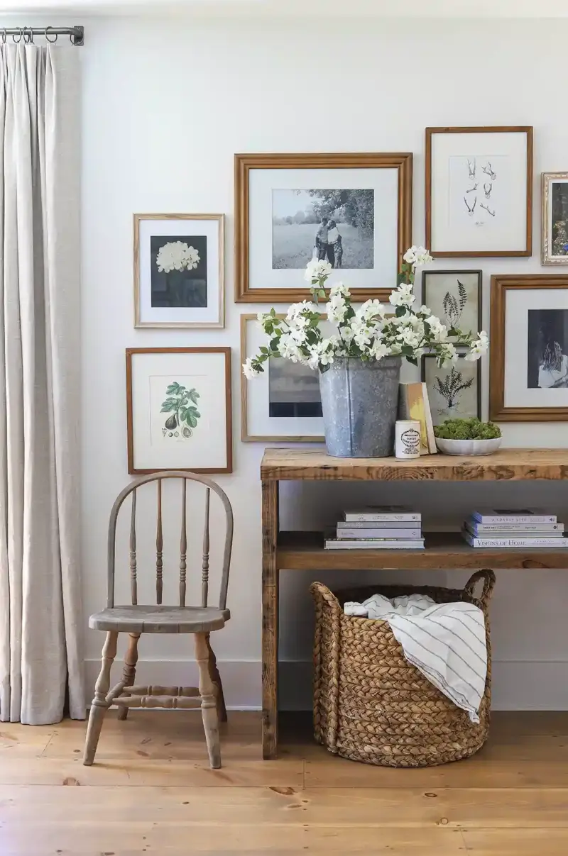 gallery wall of framed black and white and botanical art